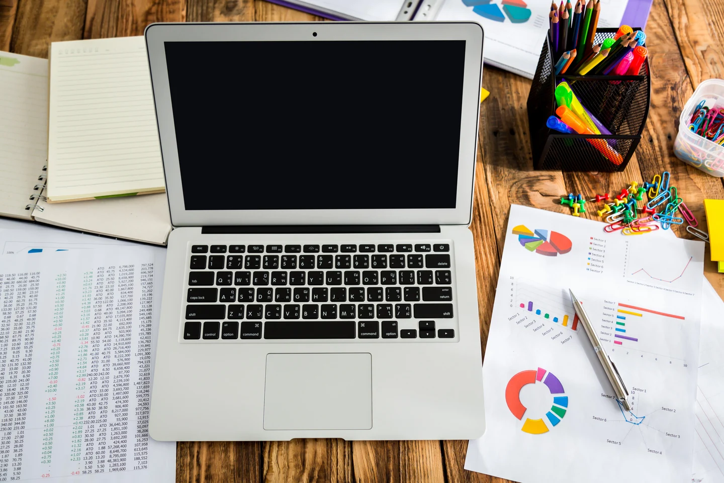 025c87b1-d83a-4443-a16f-5fd02478978d-laptop-with-pie-charts-it-other-papers.jpg